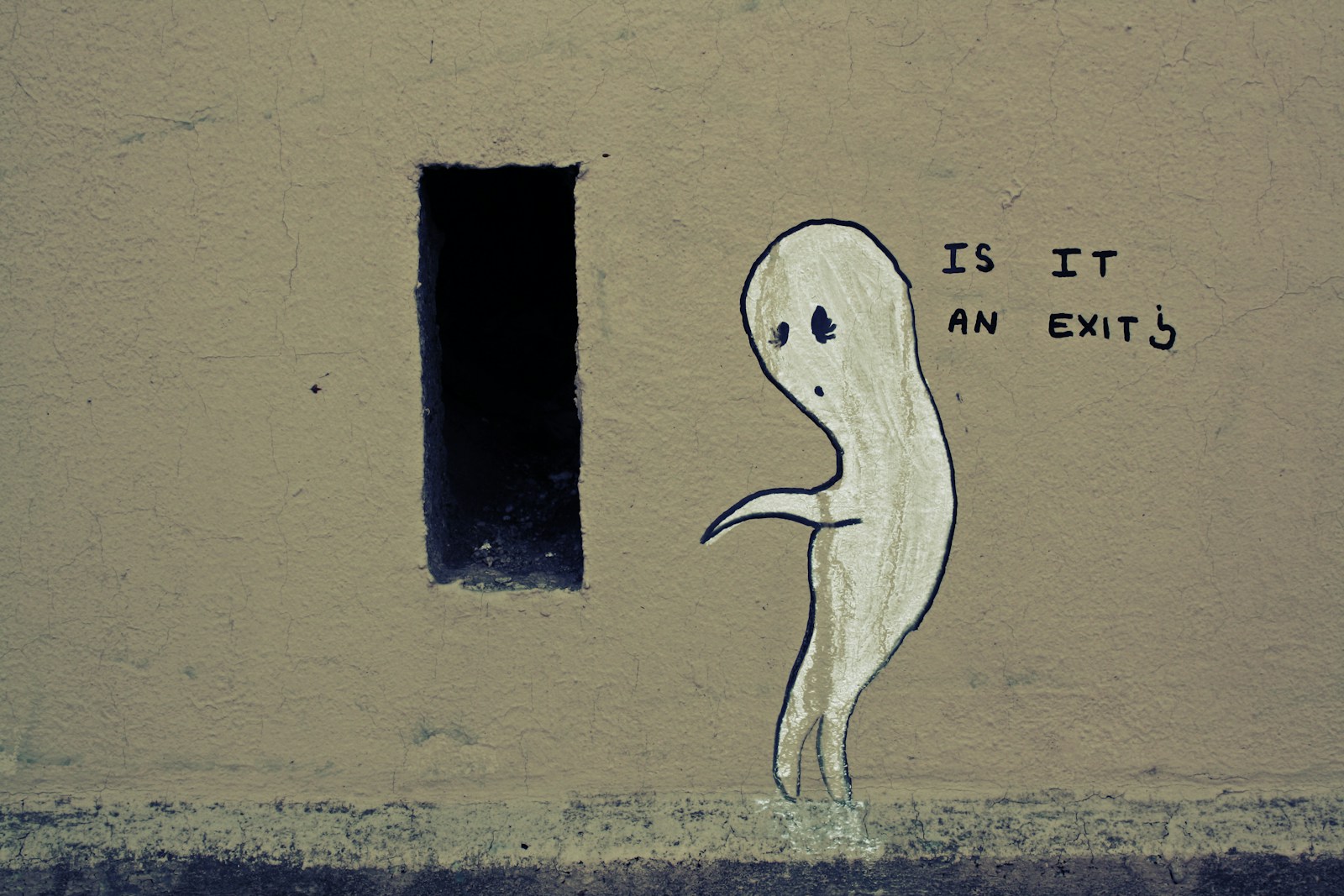 a drawing of a ghost is painted on the side of a building