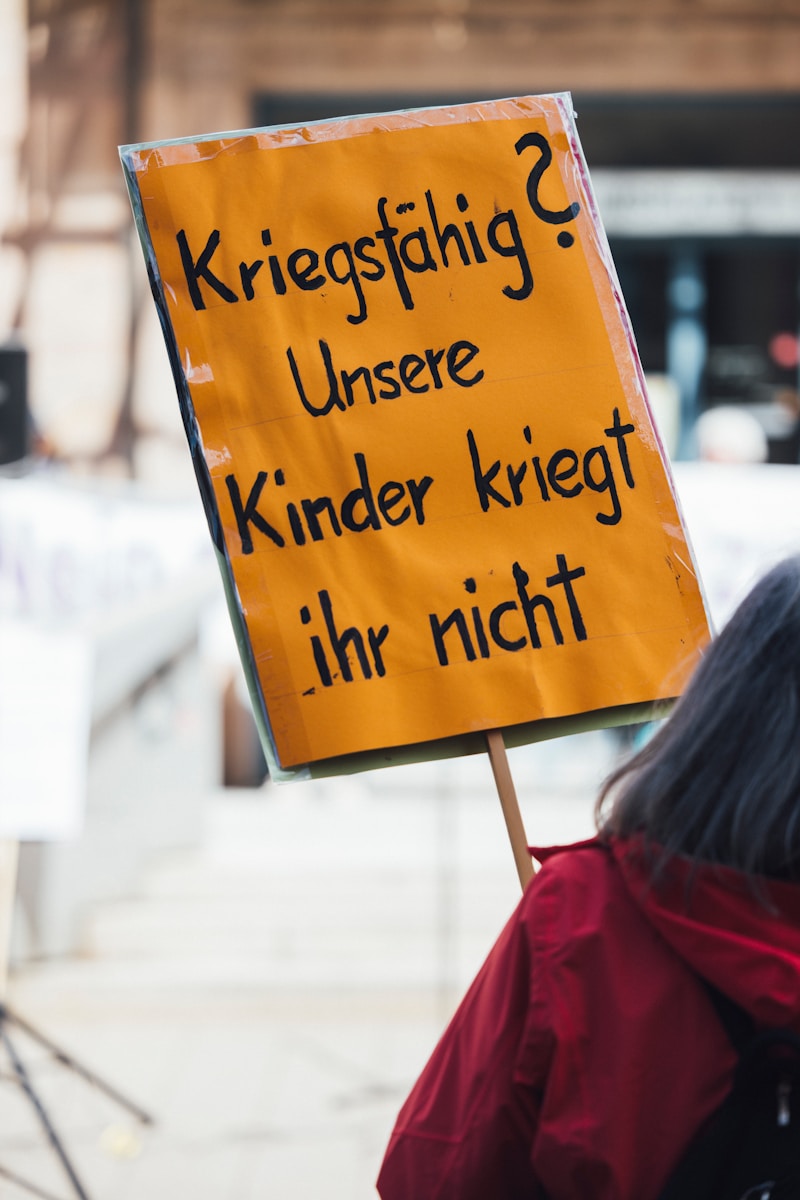 This image shows a protest sign about children and war.