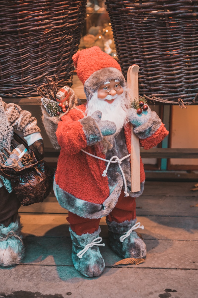 a statue of a santa clause holding a snowboard